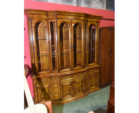 An American mid 20th Century oak Hibriten for Bernhardt, North Carolina bow fronted display bookcase, with four glazed panel 