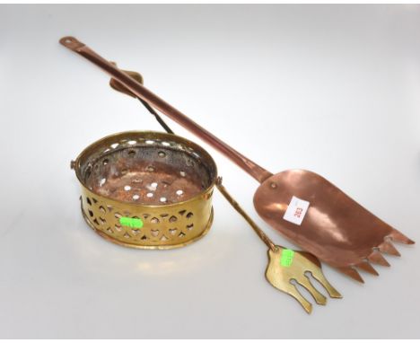 A copper Cheese shovel marked GR to handle, an oval pierced brass chestnut roasting pan and a brass toasting fork (3)