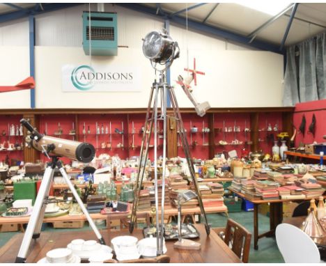 A vintage style chrome studio lamp on a tripod base