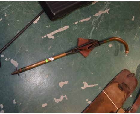 SHOOTING ACCESSORIES: an unusual cane walking stick/shooting stick, c.1920's with locking collar and leather tri-form seat.