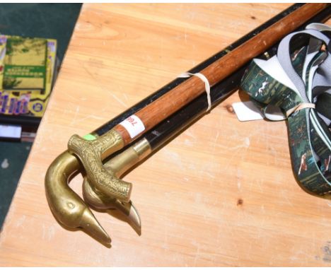 A group of three walking stick each with a brass animal head handle