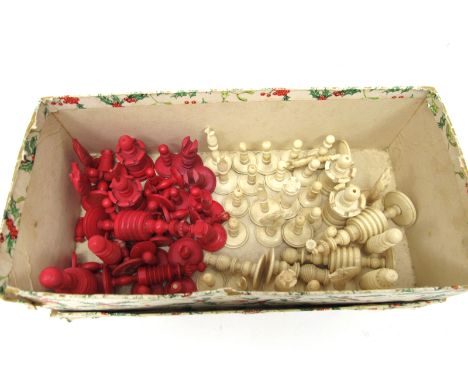 A Late XIX Century Carved Bone Chess Set, one side natural, the other stained red, 3 - 8.5cm high and a part set of similar d