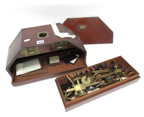 A Late XIX Century Brass Microscope, (incomplete), with lenses, slides and accessories, in a fitted mahogany and brass bound 