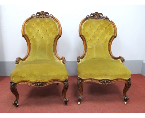 A Pair of XIX Century Walnut Framed Nursing Chairs, each with pokerwork and scroll carved cresting, serpentine front, on squa