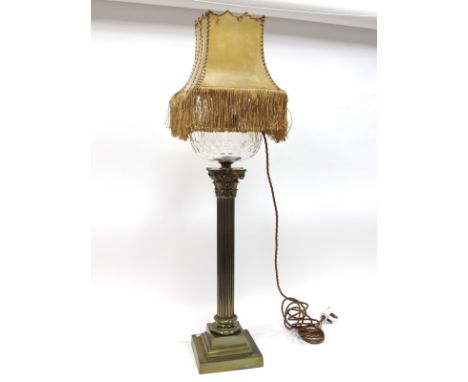 A Brass Early XX Century Oil Lamp, (converted to an electric table lamp), the Corinthian column raised on a stepped square ba