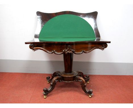 A XIX Century Rosewood Serpentine Shaped Card Table, with fold-over top and baize interior, the shaped frieze with applied de