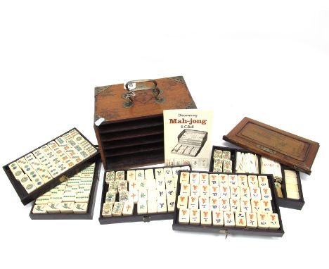 An Early XX Century Mah-Jong Set, contained in a five drawer hardwood carry case decorated with mountain scenes, with lift-ou
