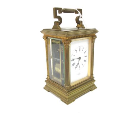 An Early XX Century French Repeater Carriage Clock, the brass case with Corinthian columns and bevelled glass panels, the whi
