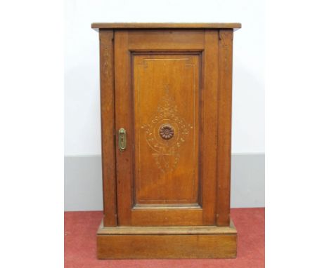 An Early XX Century Walnut Bedside Cupboard, with a low back, panelled door, on plinth base, 45cm wide.