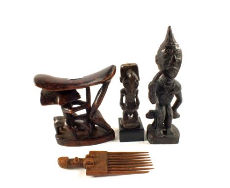 An African tribal headrest and two others figures, probably Congo and a comb