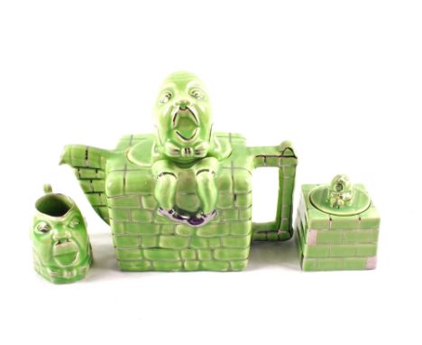 An Art Deco Lingard green glazed Humpty Dumpty teapot, jug and sucrier