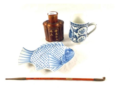 An 18th Century Chinese blue and white tankard (damaged), a Pewter tea caddy, an Opium pipe and a Japanese fish plate (repair