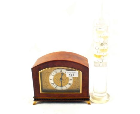 A small Walnut case mantel clock with silvered chapter ring, eight day platform movement and a Galileo thermometer