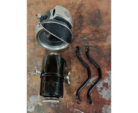 A restored King of the Road acetylene 4 1/2" motorcycle lamp, with separate carbide container and a pair of brackets.