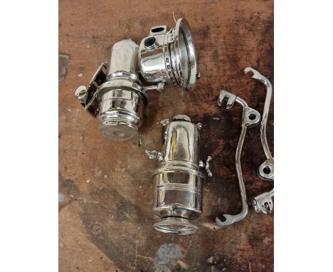 A restored King of the Road acetylene 4" chrome motorcycle lamp, with separate carbide container and a pair of brackets.