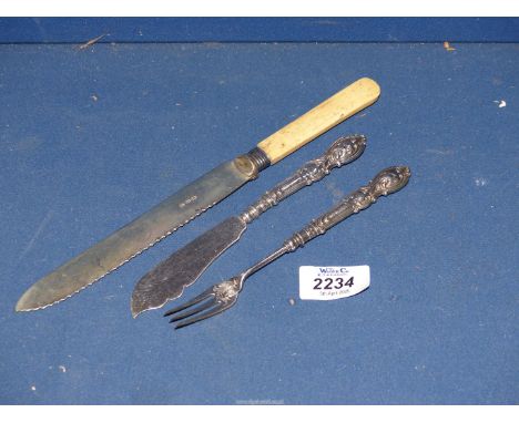 A Silver handled butter knife and pickle fork and a silver collared bread knife.
