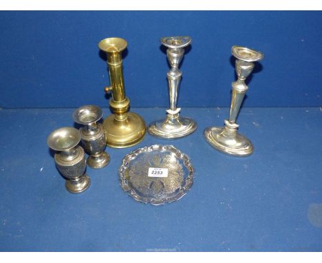 A brass ejector candlestick, a pair of plate oval candlesticks, a pair of Indian white metal vases and a plate on copper tray