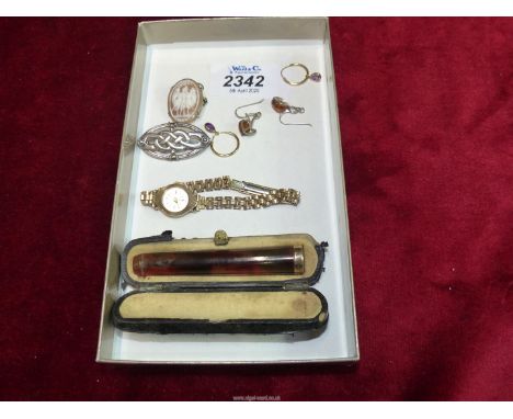 A ladies gold case Cocktail watch, gold tip cheroot in case, silver Celtic brooch and a continental gold cameo brooch.