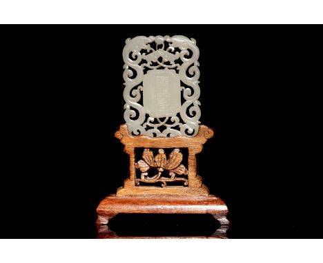 A Chinese white jade plaque with dragons and taoist symbols, 19th C.  Dim.: 5,5 x 4 cmH.: 10 cm (incl. stand)  Condition repo