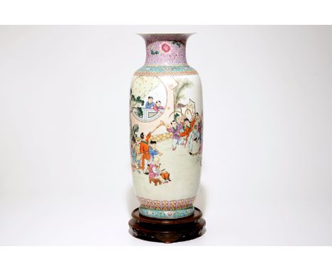 A large Chinese famille rose vase with playing boys, on a wooden stand, 20th C.  H.: 64,5 cm (incl. stand)  Condition reports