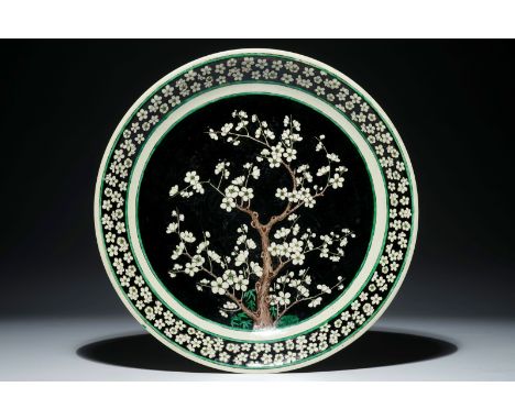A Chinese famille noire on biscuit prunus tree charger, Kangxi  Dia.: 40 cm - H.: 6,5 cm  Condition reports and high resoluti