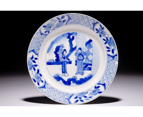 A Chinese blue and white plate with figures in the garden, Kangxi mark and of the period  Dia.: 21 cm  Condition reports and 