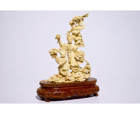 A Chinese carved ivory group of Lan Cai He with a servant, early 20th C.  H.: 35 cm - Dim.: 27 x 12 cm (the base)  Condition 