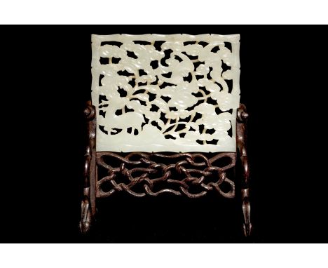 A reticulated Chinese celadon jade plaque with a deer and a bat, on wooden stand, 19th C.  Dim.: 8,5 x 7 cm (the plaque)H.: 1