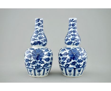 A pair of Chinese blue and white lotus scroll double gourd vases, Xuande mark, 19th C.  H.: 20 cm  Condition reports and high