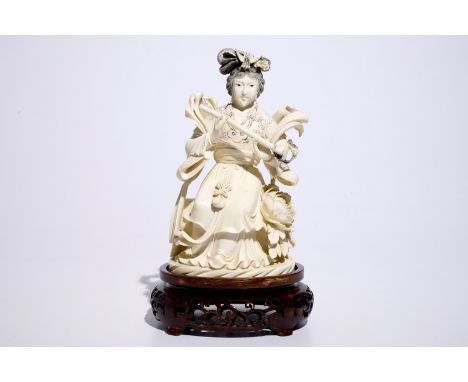 A Chinese ivory figure of a lady playing a flute on wooden base, early 20th C.  H.: 24,5 cm  Condition reports and high resol