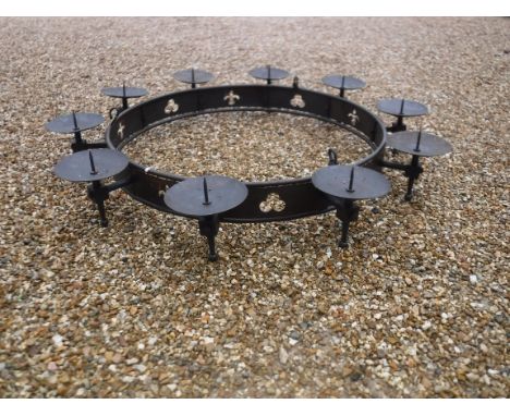 A modern wrought iron hanging ceiling light in the Gothic style with ten pricket candle holders above a pierced banded framew