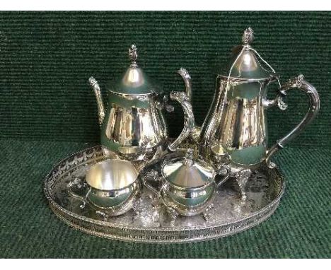A plated four piece tea service on gallery tray 