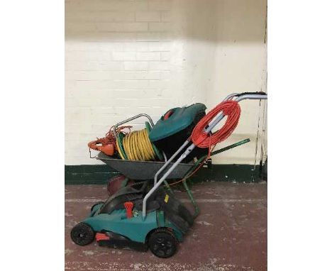 A Bosch lawn mower, wheel barrow, garden strimmer, tools, hose, step ladder etc 
