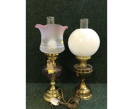 A brass oil lamp with etched glass shade and one other  