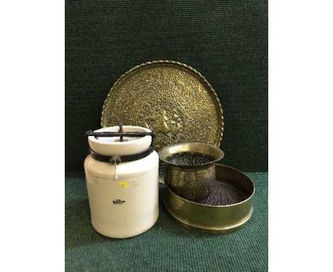 A Royal Doulton ceramic urn, embossed brass charger, two other pieces of brass ware 