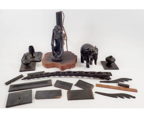 A box of carved  ebony items including African elephant, table lamp etc. 