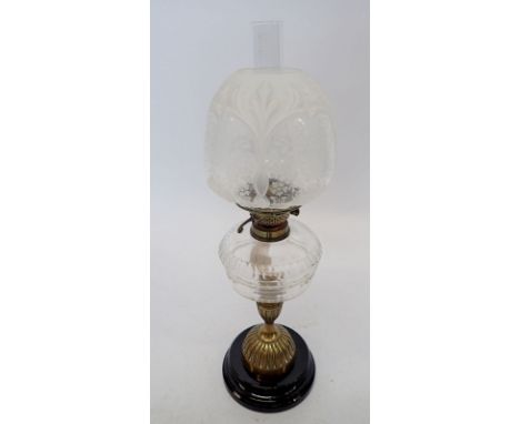 A Victorian brass oil lamp with glass shade and funnel 