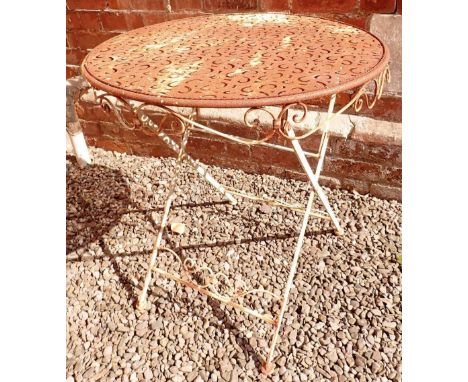 A vintage metal painted circular garden table with pierced design top with scrollwork decoration 