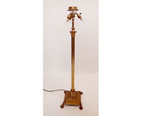 An early 20th century brass corinthian column triple light standard lamp, all on paw feet 