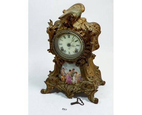 A 19th century gilt metal mantel clock inset porcelain panel painted classical scene with Ansonia movement, 32cm tall 
