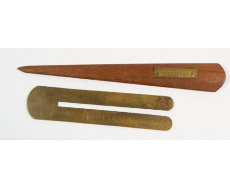 A WWII brass button stick and an HMS Iron Duke teak paperknife 