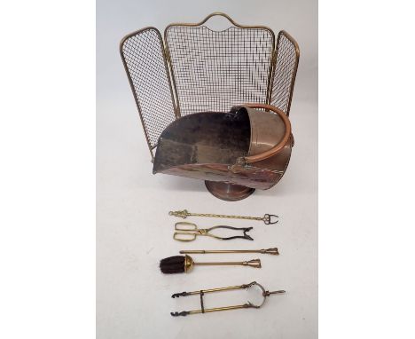A copper helmet form coal scuttle, brass mesh firescreen, fireside set etc. 