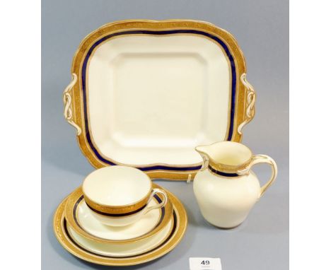 A Cauldon blue and gilt tea service comprising: nine cups and eleven saucers, twelve tea plates, two cake plates and jug 