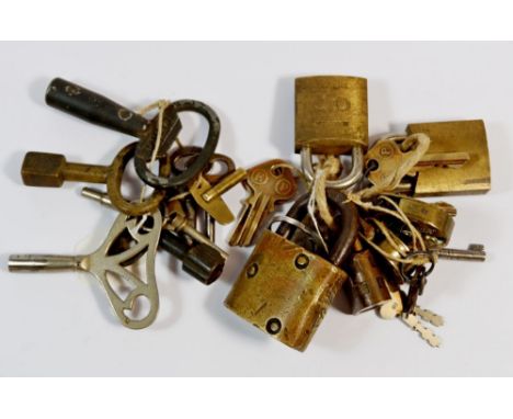 A collection of various padlocks with keys and clock and watch kegs 
