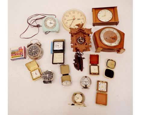 A box of several clocks including Smiths examples, a wooden cuckoo clock, travel clocks etc. 