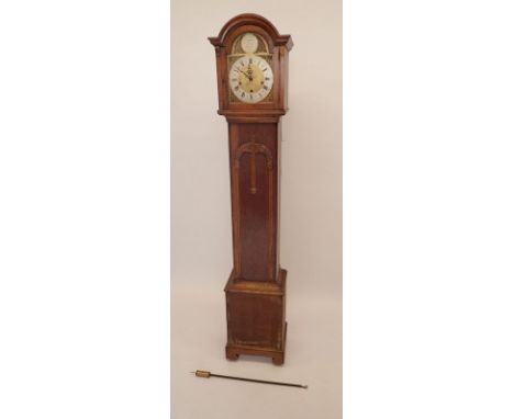 A 1930's oak grandmother clock with eight day chiming movement, the brass dial with arched hood and silvered chapter ring 
