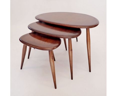 An Ercol nest of three pebble tables, largest table 65cm wide 