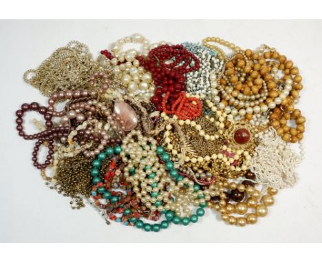 A box of vintage costume jewellery comprising necklaces and beads 