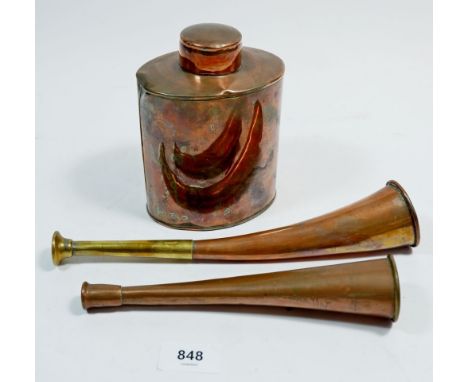 Two copper hunting horns and a copper oval tea caddy 