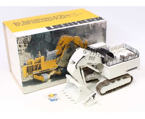A Conrad 1/50 scale Liebherr No. 2811 hydraulic excavator 996 Litronic housed in polystyrene with a pictorial card sleeve